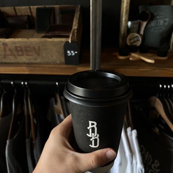 Bond & Bevel - a hand holding a coffee cup - Coffee & Tea Near Me - Caldwell, Idaho