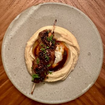 Blend Catering - Appetizer: Smoked bison skewer, chickpea miso hummus, Urfa chili, pomegranate, mint, brown butter. Beautiful and delicious! - Caterers Near Me Blend Catering - Appetizer: Smoked bison skewer, chickpea miso hummus, Urfa chili, pomegranate, mint, brown butter. Beautiful and delicious! - Caterers Near Me