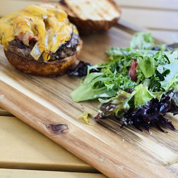 Jasper's Backyard - a burger and a salad on a cutting board - Sports Bars Near Me - Conshohocken, Pennsylvania