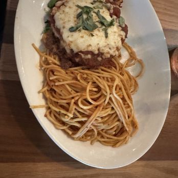 BJ's Restaurant & Brewhouse - Italian chicken parmigiana with spaghetti, chopped fresh basil leaves - New American Near Me - San Bernardino, California BJ's Restaurant & Brewhouse - Italian chicken parmigiana with spaghetti, chopped fresh basil leaves - New American Near Me - San Bernardino, California