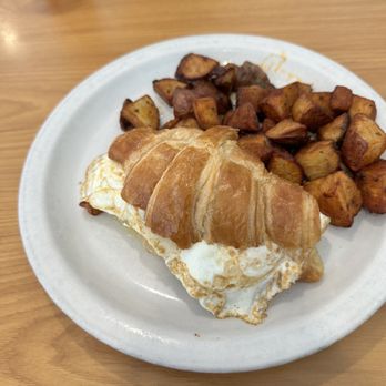 La Croisette - Bacon croissant egg sandwich with home fries - Breakfast & Brunch Near Me - St. Pete Beach, Florida La Croisette - Bacon croissant egg sandwich with home fries - Breakfast & Brunch Near Me - St. Pete Beach, Florida