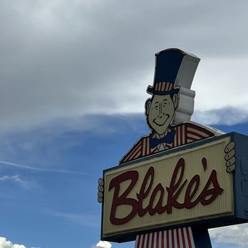 Blake's Lotaburger - a man holding a sign - Burgers Near Me - Santa Fe, New Mexico