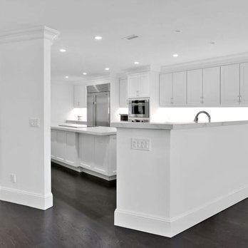 Kentstruction - a kitchen with white cabinets and wood floors - General Contractors Near Me - Medford, New York Kentstruction - a kitchen with white cabinets and wood floors - General Contractors Near Me - Medford, New York