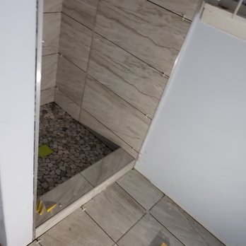 Acuity Builders & Construction - Bathroom floor rolled into the shower with beautiful stone flooring. - Damage Restoration Near Me - Phoenix, Arizona