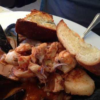 Sandbar & Grill - Cioppino. Tons of seafood and a broth that'll make you feel comforted on an overcast day. - Seafood Near Me - Monterey, California Sandbar & Grill - Cioppino. Tons of seafood and a broth that'll make you feel comforted on an overcast day. - Seafood Near Me - Monterey, California