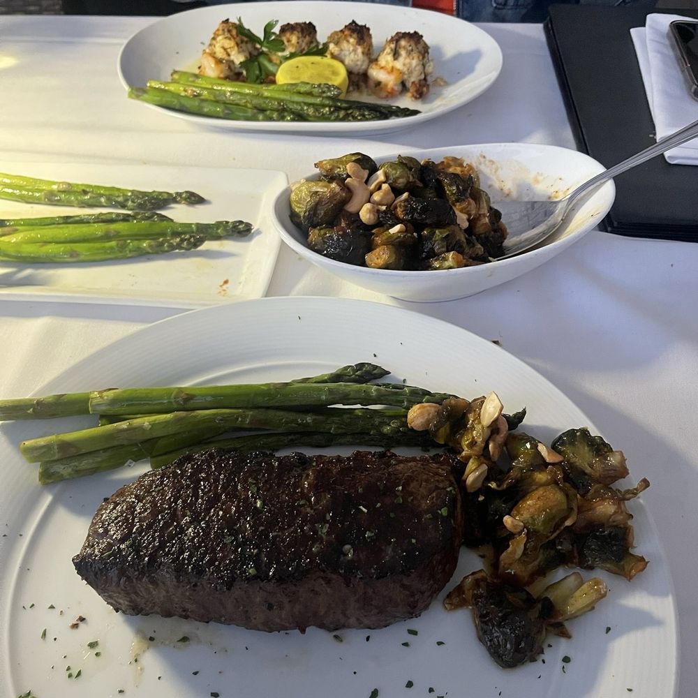 Eddie V's Prime Seafood - 12 oz Snake River Farms Gold Grade Wagyu Strip Honey Sriracha Roasted Brussels Sprouts with Cashews Grilled Asparagus - Seafood Near Me - La Jolla, California Eddie V's Prime Seafood - 12 oz Snake River Farms Gold Grade Wagyu Strip Honey Sriracha Roasted Brussels Sprouts with Cashews Grilled Asparagus - Seafood Near Me - La Jolla, California