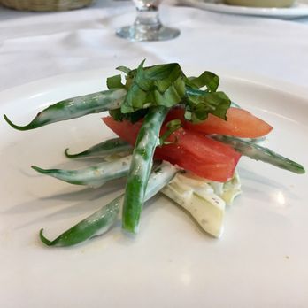 Courses - a plate of food on a table - New American Near Me - Houston, Texas