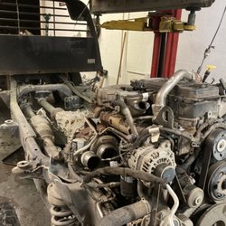 Modern Diesel Repair And Performance - Lifted cab off frame for replacement of back timing cover gasket.