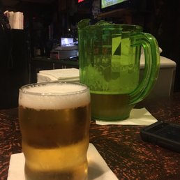 a glass of beer and a pitcher