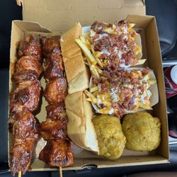 Los Pinchos De Mi Abuela - Pinchos de mi abuela combo: 2 pinchos, 2 pieces of garlic bread, 2 orders of loaded fries, 2 mofongo balls, and 2 drinks.