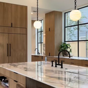 Precise Building & Restoration - a kitchen with a marble island - General Contractors Near Me - Los Angeles, California Precise Building & Restoration - a kitchen with a marble island - General Contractors Near Me - Los Angeles, California