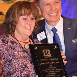 Karyn Davis, McGrew Real Estate - Lawrence Board of Realtors 2018 President Henry Wertin gives Janet Briethaupt the Newcomer Award at the annual LBOR Awards Banquet.
