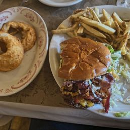 Bison smashed burger with fries and onion rings.