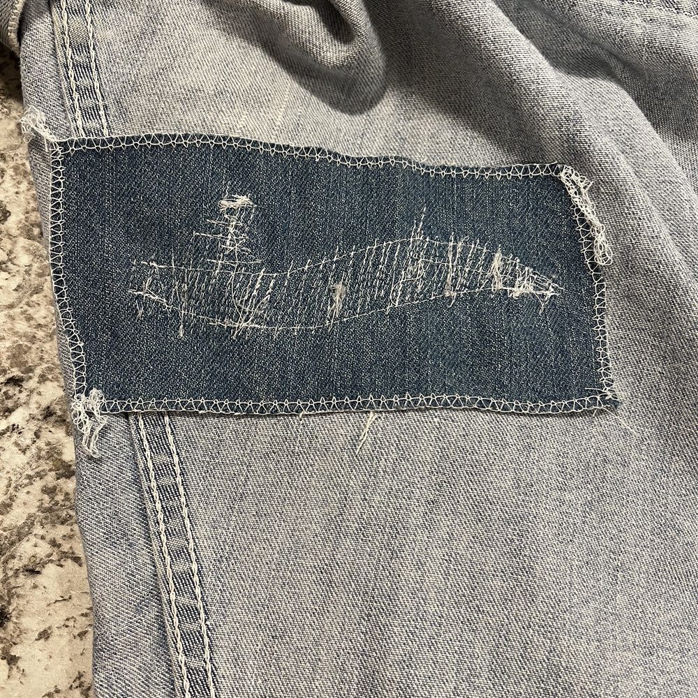 Sanitary Cleaners - inside of the patch: way too large for the repair, and the "~" outline shows where the hole could have been closed. - Sewing & Alterations Near Me - Rock Island, Illinois Sanitary Cleaners - inside of the patch: way too large for the repair, and the "~" outline shows where the hole could have been closed. - Sewing & Alterations Near Me - Rock Island, Illinois