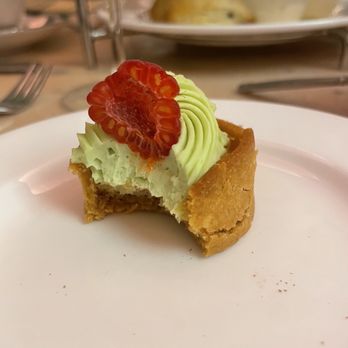 Camellias - Pistachio cake topped with a raspberry - Champagne Bars Near Me - Charleston, South Carolina