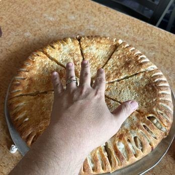 Jailhouse Pizza - Hand for scale on the size of the pizza - Pizza Near Me - Brandenburg, Kentucky Jailhouse Pizza - Hand for scale on the size of the pizza - Pizza Near Me - Brandenburg, Kentucky