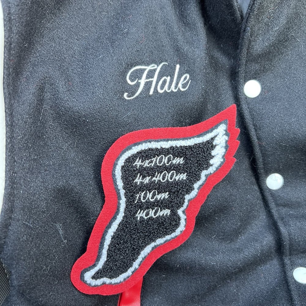 Embroidered name on varsity jacket as well as embroidery of events on patch Embroidered name on varsity jacket as well as embroidery of events on patch