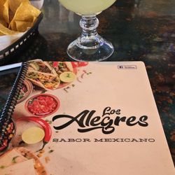 Los Alegres - Cover of many with address and a house margarita with an extra.shot of tequila added.