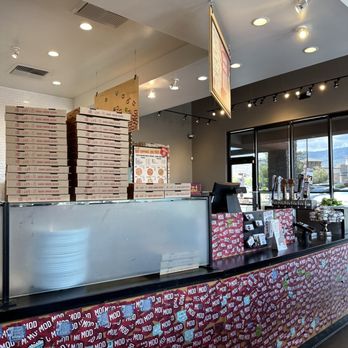 MOD Pizza - a counter with pizza boxes on it - Fast Food Near Me - Reno, Nevada