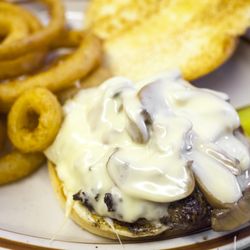 The Den Bar and Grill - Mushroom & Swiss Burger with fully flavored Onion Rings!