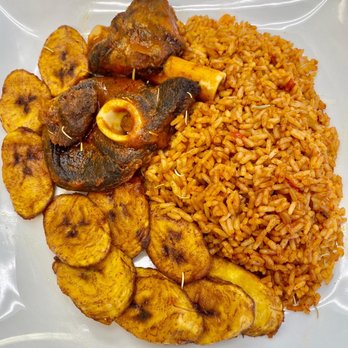 Mosun's Kitchen - Jollof Rice platter. Serverd with plantains and lamb. So so delicious. - African Near Me - Gaithersburg, Maryland
