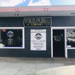 Our Grand Opening banner by Sprinting! - The image shows the exterior of P.B.S. Pub & Company, featuring a sign, a grand opening poster, and neon signs in the windows, with a sidewalk in front.