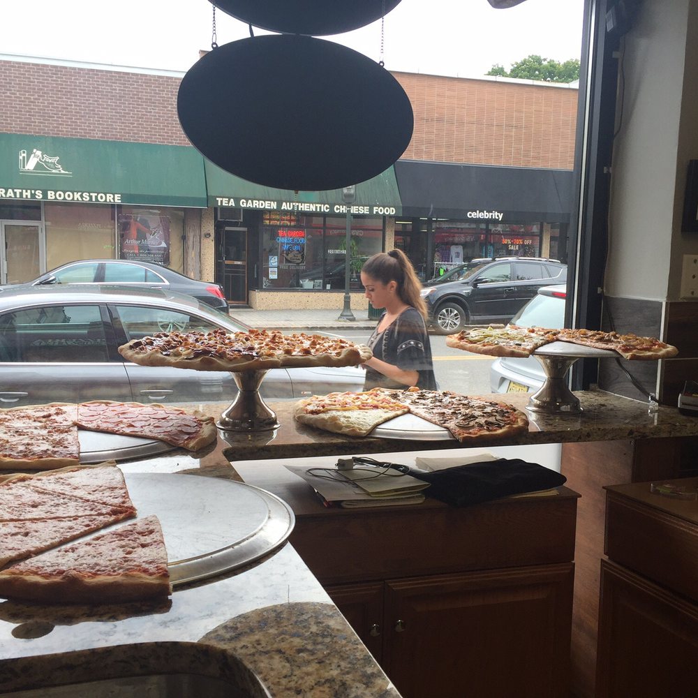 Paulie's Pizza & Wings - a woman in the window - Chicken Wings Near Me - Tenafly, New Jersey