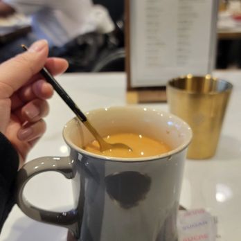 LC Cafe - Complimentary HK Milk Tea. They serve it with sugar on the side with a cute spoon and coaster - Hong Kong Style Cafe Near Me - Toronto, Ontario