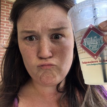 Fudgery Inc - a woman holding a drink - Candy Stores Near Me - Myrtle Beach, South Carolina