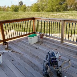 Intricate Painting - In process of staining deck Belleville Illinois summer of 2019
