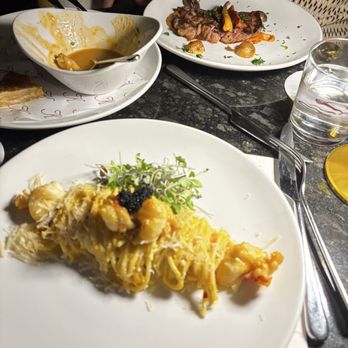 The Kennedy - Lobster spaghetti twist and the prime wagyu ribeye, main course meals. In the middle, is lobster bisque which is an appetizer - Piano Bars Near Me - Houston, Texas The Kennedy - Lobster spaghetti twist and the prime wagyu ribeye, main course meals. In the middle, is lobster bisque which is an appetizer - Piano Bars Near Me - Houston, Texas