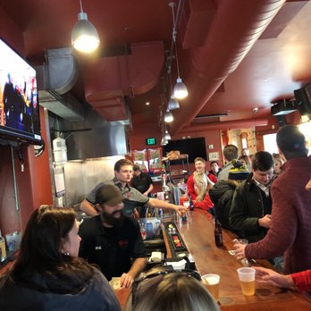Wando's - a group of people sitting at a bar - Bars Near Me - Madison, Wisconsin