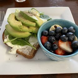 Palato Cafe - Avocado toast with a side of fruit.