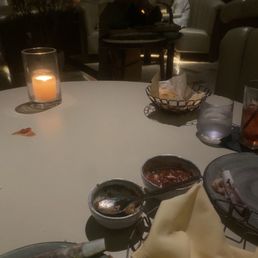 Waiter bagging our left overs. I guess the didn't teach him to do one table at a time. He had previous dishes from other table. Waiter bagging our left overs. I guess the didn't teach him to do one table at a time. He had previous dishes from other table.