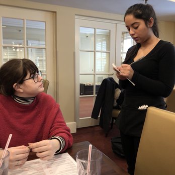 Goldstein Alumni & Faculty Center - a woman sitting at a table with a notebook and pen in front of her - Cafeteria Near Me - Syracuse, New York