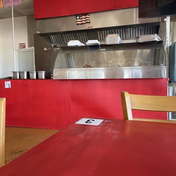 Carnitas El Guero - a red table and chairs - Tacos Near Me - Cedar Creek, Texas