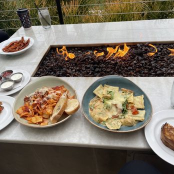 Vista.Kitchen.Bar - plates of food on a table - Comfort Food Near Me - Newport Beach, California Vista.Kitchen.Bar - plates of food on a table - Comfort Food Near Me - Newport Beach, California