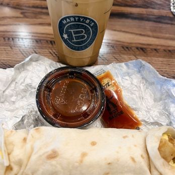 Marty B's Coffee - Egg, cheese and potato taco. Superb with Texas Pete hot sauce. Paired with iced toffee coffee latte. - Desserts Near Me - Bartonville, Texas Marty B's Coffee - Egg, cheese and potato taco. Superb with Texas Pete hot sauce. Paired with iced toffee coffee latte. - Desserts Near Me - Bartonville, Texas