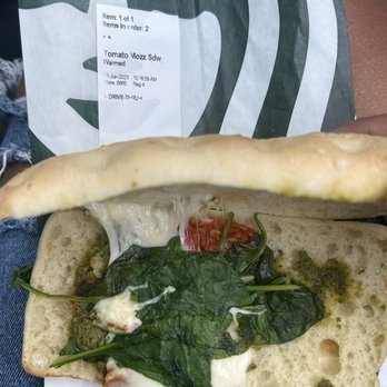 Starbucks - a person holding a sandwich with spinach and cheese - Coffee & Tea Near Me - Reedley, California