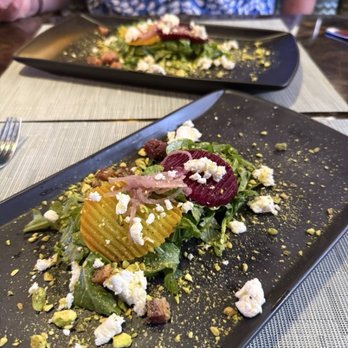 Bimini Steakhouse - The beat salad. Just Wow!   Sprinkled with pistachio and pork belly and goat cheese.  On a bed of arugula. Delish - Steakhouses Near Me - Reno, Nevada