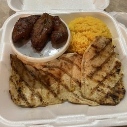 grilled meat and rice in a styrofoam container grilled meat and rice in a styrofoam container