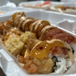 Koi Koi - Koi Koi Roll   Inside: Tempura Shrimp Outside: Spicy Tuna, Tempura Shrimp Mango, Ginseng Sauce Spicy Mayo Eel Sauce