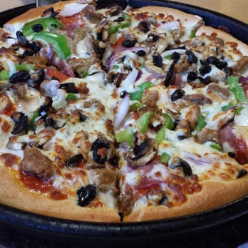 Pizza Hut - a pizza in a pan on a table - Pizza Near Me - Lihue, Hawaii