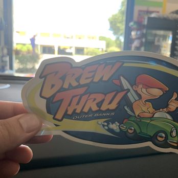 Brew Thru- Corolla - a hand holding a sticker - Convenience Stores Near Me - Corolla, North Carolina Brew Thru- Corolla - a hand holding a sticker - Convenience Stores Near Me - Corolla, North Carolina