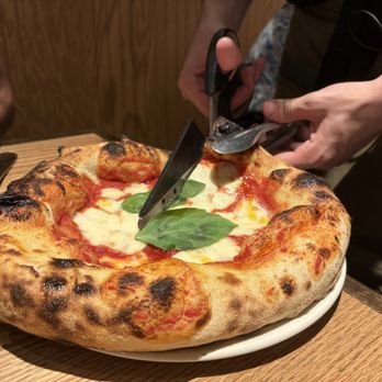 Piccolo Buco by Cooper's Hawk - Cutting Margherita with scissor! - Wine Bars Near Me - Estero, Florida