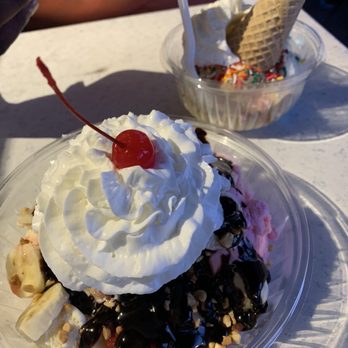 Happy Belly Ice Cream - Banana split (front) and birthday cake ice cream with sprinkles, whipped cream, and sugar cone - Ice Cream & Frozen Yogurt Near Me - Hatteras, North Carolina Happy Belly Ice Cream - Banana split (front) and birthday cake ice cream with sprinkles, whipped cream, and sugar cone - Ice Cream & Frozen Yogurt Near Me - Hatteras, North Carolina