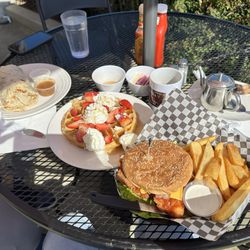 Big Breakfast Burrito, Waffle with strawberries and whip cream & spicy crispy chicken sandwich.