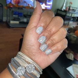 Gel polish with diamonds on the ring finger.