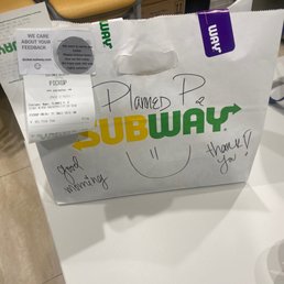 a paper bag with a sign on it a paper bag with a sign on it