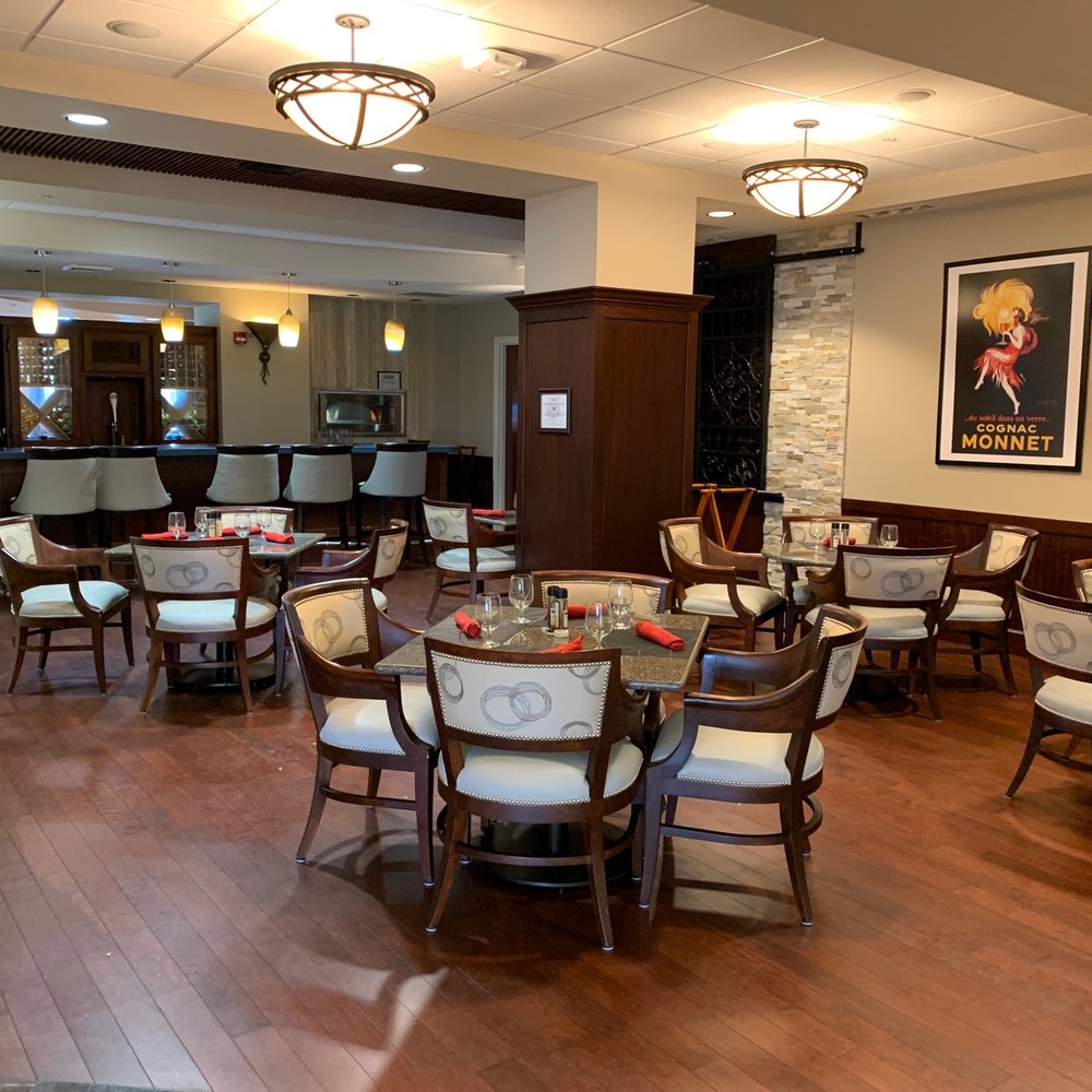 The Arlington - a dining room with tables and chairs - Pubs Near Me - Naples, Florida The Arlington - a dining room with tables and chairs - Pubs Near Me - Naples, Florida